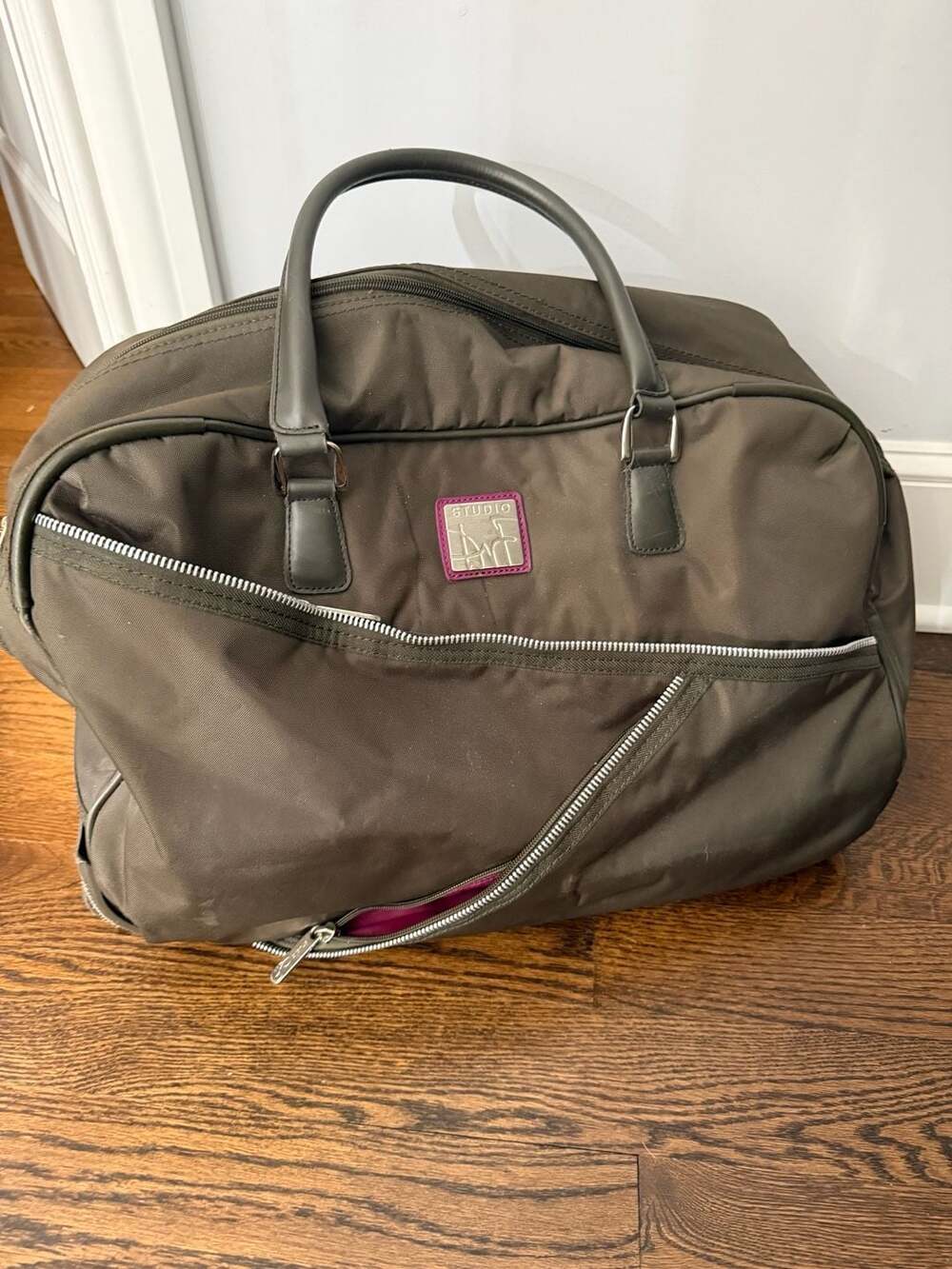 The Two Handled Carry on Bag by Diane Von Furstenburg -DvF. rolling duffle green